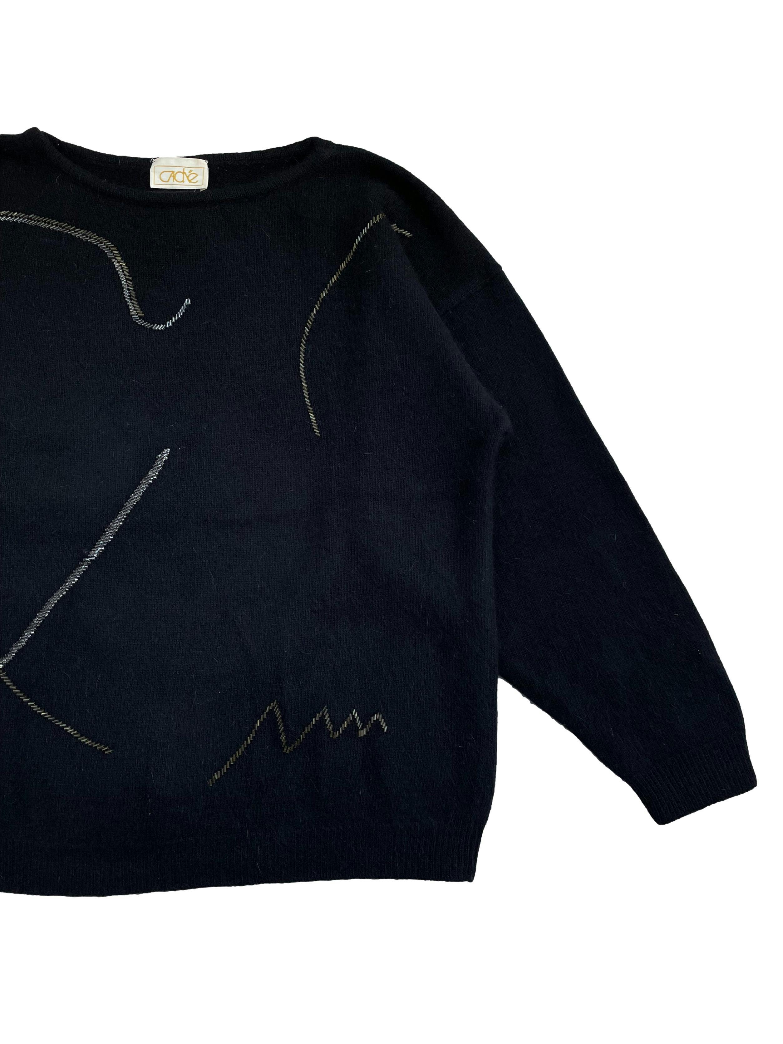 Chompa vintage negra , 50%lana 30% angora ,con bordados lineales de cuentas metálicas en delantero, mangas ligeramente murciélago .Largo 64cm.