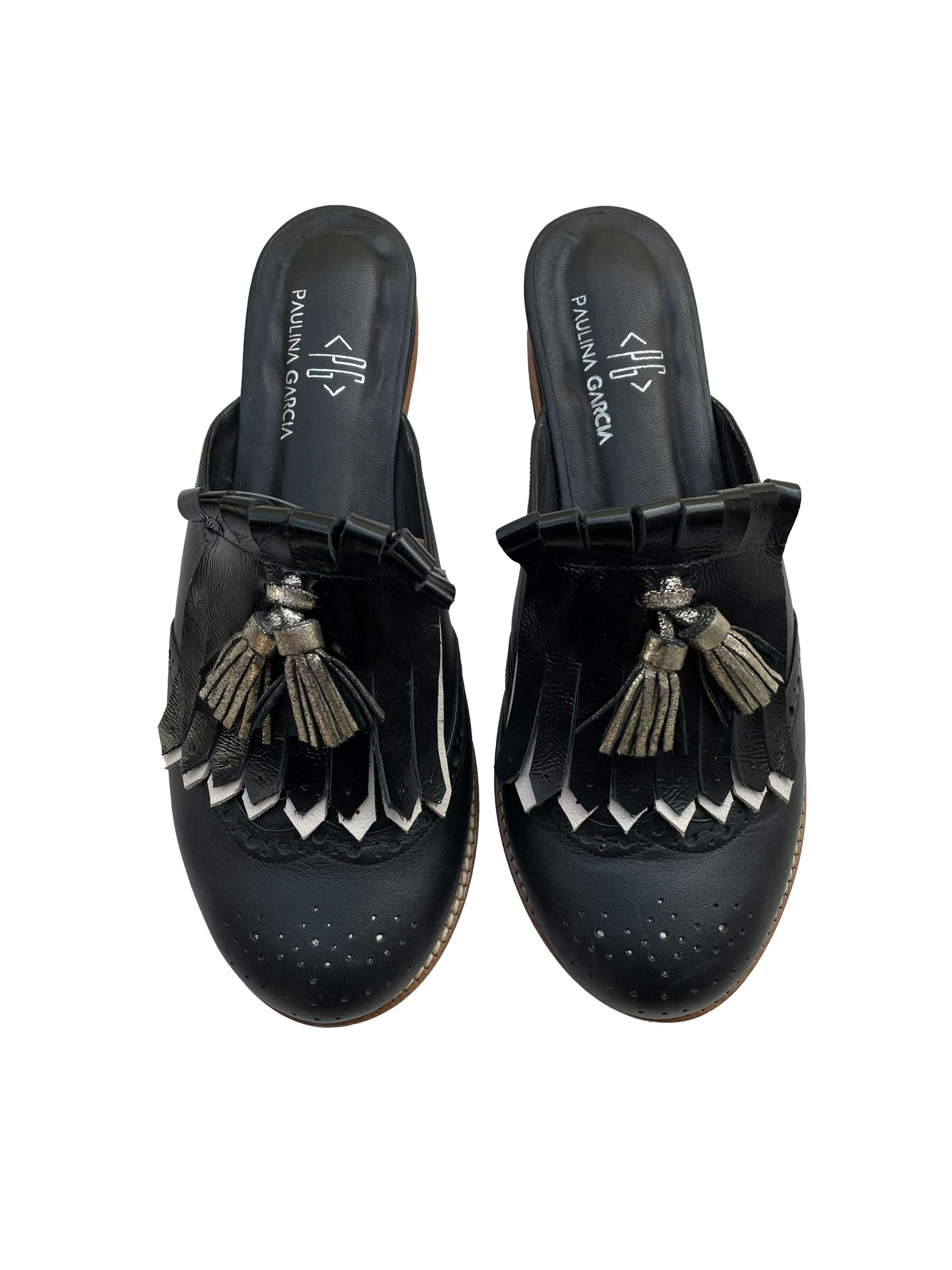 Zapatos mule Paulina Garcia, de cuero negro con flecos y borlas plateadas. Estado como nuevo. 