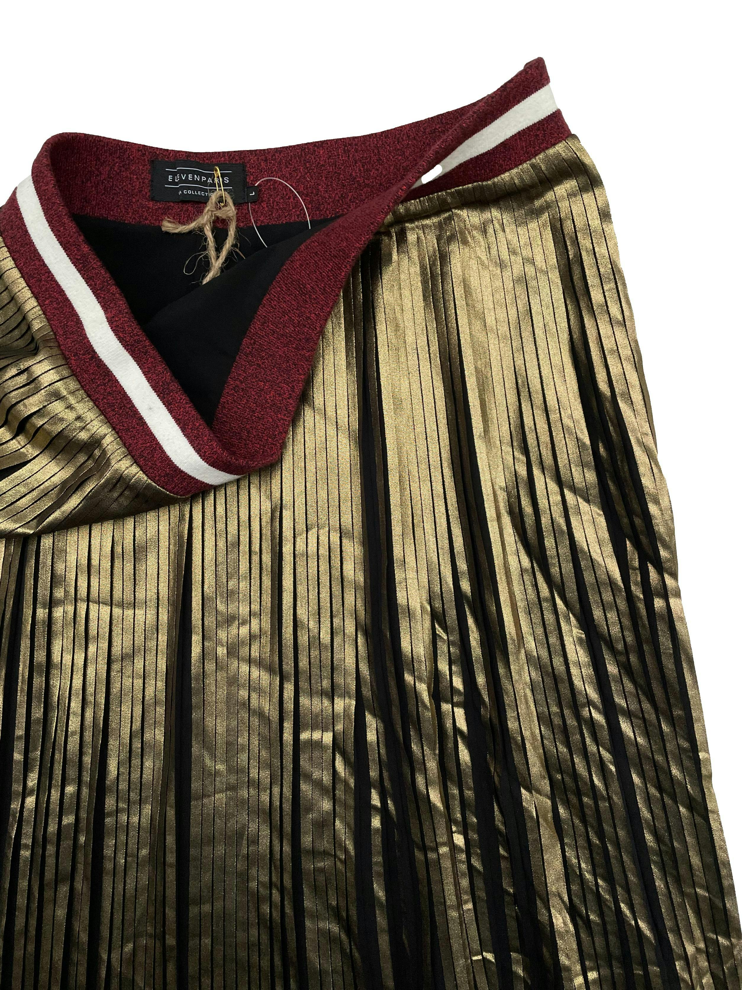 Falda midi Eleven Paris, dorada plisada, forrada, con pretina jersey y cierre lateral. Cintura 80cm Largo 77cm.